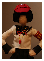 Faceless cloth doll with black hair, red hat, white shirt.